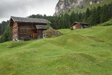 small house over a mountain pasture in Dolomites with wonderful panorama