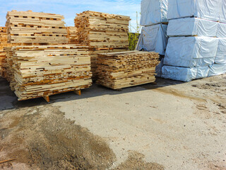 Lumber, boards, stacked. Products packed in polyethylene.
