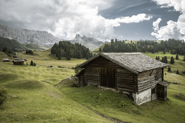 small house over a mountain pasture in Dolomites with wonderful panorama
