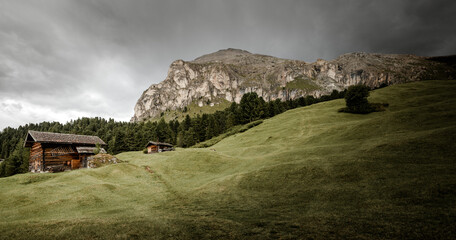 small house over a mountain pasture in Dolomites with wonderful panorama