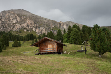 small house over a mountain pasture in Dolomites with wonderful panorama
