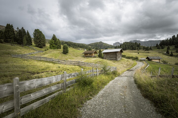 small house over a mountain pasture in Dolomites with wonderful panorama
