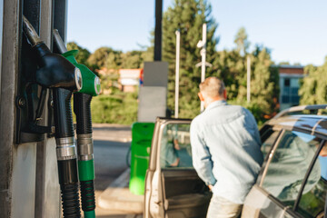 Fototapeta premium Fueling up car at modern gas station with diesel or petrol, capturing the essence of everyday travel and convenience
