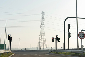 Driving through a quiet area with traffic lights and power lines on a hazy day