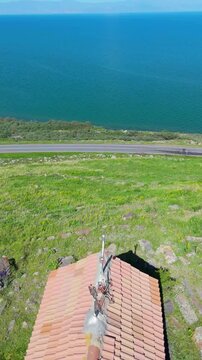 Aerial view of a tropical island with white sand beaches and volcanic features, captured by drone. Chayeri Island, Sevan, Armenia 