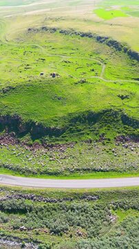 A small Church on top of a mountain. St. Hovhannes Church in Sevan taken with drone