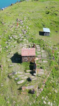A small Church on top of a mountain. St. Hovhannes Church in Sevan taken with drone