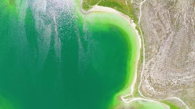 Aerial view of a tropical island with white sand beaches and volcanic features, captured by drone. Chayeri Island, Sevan, Armenia 