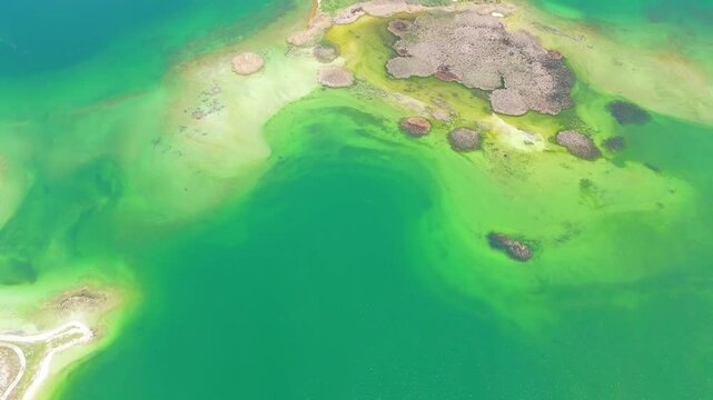 Aerial view of a tropical island with white sand beaches and volcanic features, captured by drone. Chayeri Island, Sevan, Armenia 