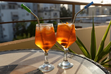Two Aperol Spritz cocktails on the table with city view