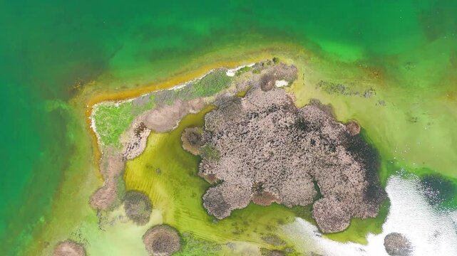 Aerial view of a tropical island with white sand beaches and volcanic features, captured by drone. Chayeri Island, Sevan, Armenia 