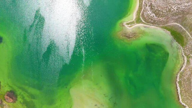 Aerial view of a tropical island with white sand beaches and volcanic features, captured by drone. Chayeri Island, Sevan, Armenia 