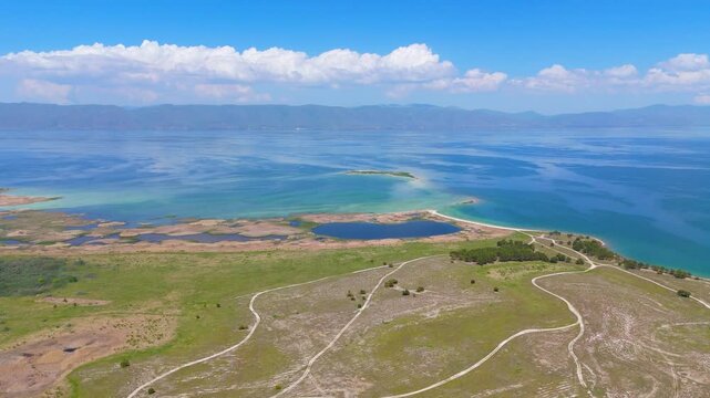 Aerial view of a tropical island with white sand beaches and volcanic features, captured by drone. Chayeri Island, Sevan, Armenia 