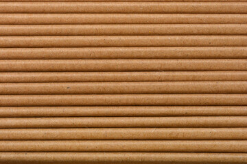 Close-up shot captures a stack of neatly arranged brown paper bags, revealing their horizontal texture and layered edges - side view