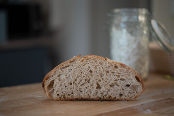 Extreme close-up shot highlighting the crispy, crackled surface of artisan sourdough bread. Perfect...