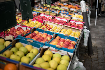 A rustic vegetable stall at an outdoor market, featuring a diverse range of locally grown produce. Great for topics on sustainability, nutrition, and agriculture.
