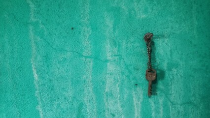 Aged Key and Chain on Aqua Background