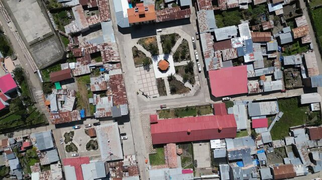 Aerial flyover looks directly down onto Cajatambo Plaza in Peru mtns