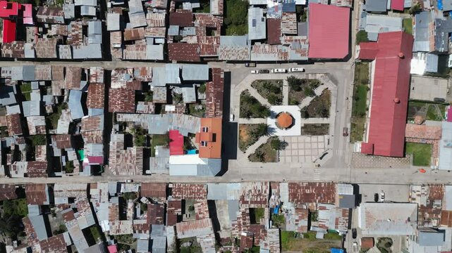 Quiet town street flyover: Cajatambo Plaza in mtns of Peru, aerial view