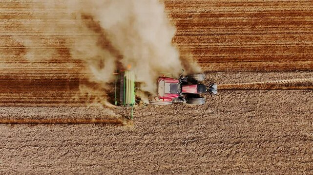 Slow motion artistic drone of ritual as soil dust whirls, sunset time, Latvia