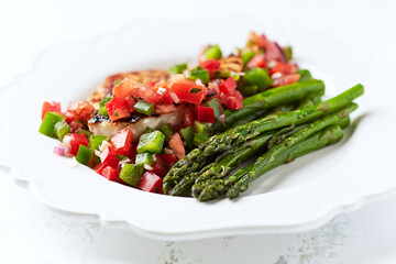 Grilled chicken fillet with asparagus and tomato salsa.