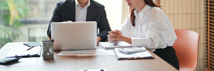 Two women working together in business coaching session at office to build career and workplace...