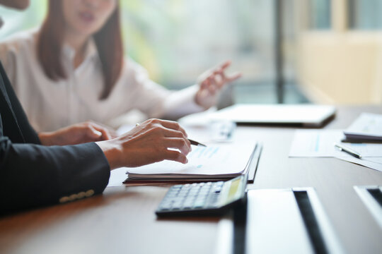 Two women working together in business coaching session at office to build career and workplace skills