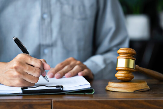 trusted lawyer and client finalizing legal documents and agreement at office before court case filing