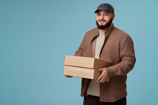 Courier holding boxes on a blue background