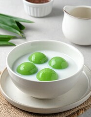 Traditional Bubur Sumsum with Palm Sugar Syrup and Coconut Milk on Ceramic Bowl Setting