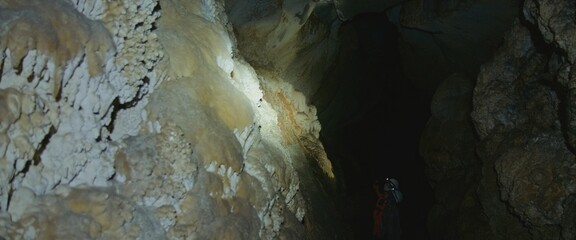 The woman tourist marveled at the rock stone formations in the dark cavern. Its an attraction for...