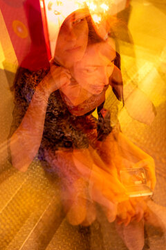Artistic multiple exposure of a woman sitting at a bumper car with candy at Kiliani Volksfest in W�rzburg