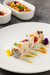 Rolled crispy crepe filled with seafood, herbs, and microgreens