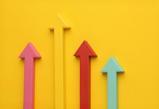 Multicoloured arrows pointing up and down. Symbolise growth progress, success in business finance. Rising bars of graphs represent market trends, return on investment, business development, financial