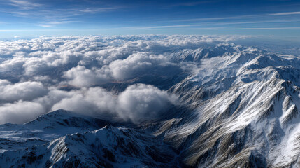 Breathtaking mountain landscape with snow capped peaks and fluffy clouds, showcasing nature beauty and serenity