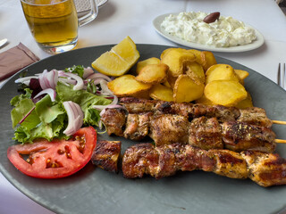 souvlaki skewers with tzatziki and garlic potatoes