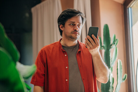 financial crisis in the usa, stocks falling, man watching quotes, horror on face, panic, lost retirement savings