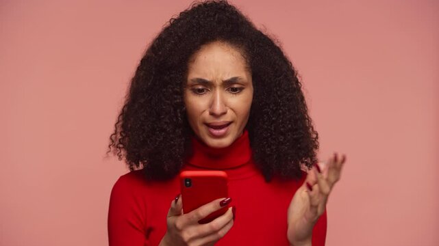 Frustrated woman reacting to smartphone with confused expression