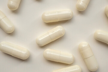 White medicine pills capsule on white background