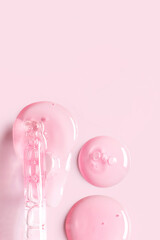 pipette drop of serum test on a light pink background