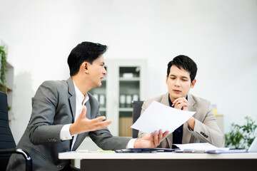 Frustrated manager scolds employee in office over financial error. Concept of workplace stress, reporting issues, conflict