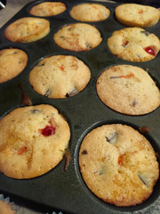 Homemade chocolate and cherry muffins on a muffin tin