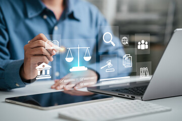 Hand of the businessman or Lawyer with legal services icon on the laptop screen for Legal advice...