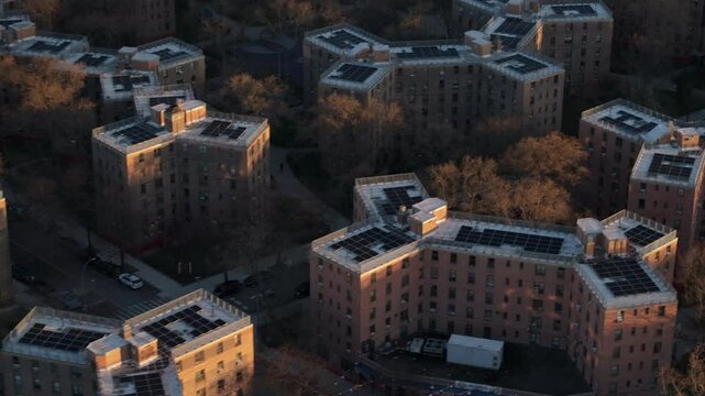 Aerial view of solar panels on public housing project buildings. Shot at sunrise in Queensbridge, Queens, New York City.
