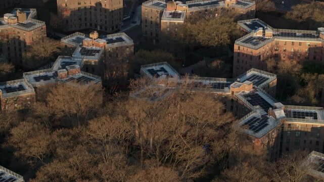 Aerial view of solar panels on public housing project buildings. Shot at sunrise in Queensbridge, Queens, New York City.