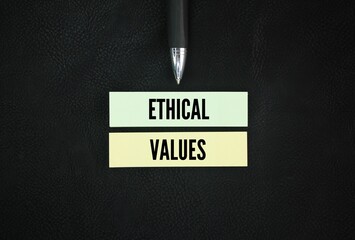 Colored pen and paper with the word ethical values. the core moral principles that guide how...
