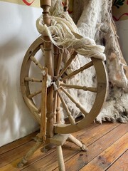 Wooden spinning wheel with threads, spindle