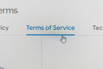 computer screen showing a cursor pointing to a Terms of Service link on a website.