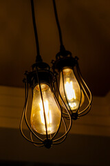 Three light bulbs are hanging down from the ceiling in a dark room