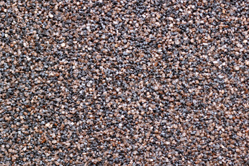 A detailed close up of a pile composed of brown and black gravel